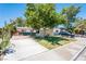 Inviting single-story home with lush front yard, mature shade trees, and a large driveway at 1904 Fontenelle St, Las Vegas, NV 89102