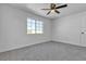 Comfortable bedroom with neutral walls, ceiling fan, and large sunny window at 220 Mission Catalina Ln # 208, Las Vegas, NV 89107
