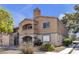 Charming two-story condo with a red tile roof and stucco exterior, offering a cozy and inviting curb appeal at 220 Mission Catalina Ln # 208, Las Vegas, NV 89107