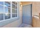Close-up of the unit entrance with a gray front door and window, providing a secure and private entry at 220 Mission Catalina Ln # 208, Las Vegas, NV 89107