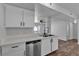 Modern kitchen boasts stainless steel dishwasher, white cabinets, and hardwood floors at 220 Mission Catalina Ln # 208, Las Vegas, NV 89107