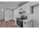 Well-lit kitchen features white cabinetry, stainless steel appliances, and wood-look floors at 220 Mission Catalina Ln # 208, Las Vegas, NV 89107