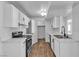Bright kitchen features white cabinets, modern appliances, and hardwood floors, creating a functional and appealing space at 220 Mission Catalina Ln # 208, Las Vegas, NV 89107