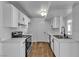 Modern kitchen with white cabinets, stainless steel appliances, and hardwood floors, offering a clean and stylish cooking space at 220 Mission Catalina Ln # 208, Las Vegas, NV 89107