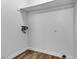 Functional laundry room with wood-look flooring, white walls and baseboards at 220 Mission Catalina Ln # 208, Las Vegas, NV 89107