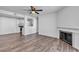 Spacious living room with hardwood floors, a fireplace, and open view to the kitchen, creating an inviting atmosphere at 220 Mission Catalina Ln # 208, Las Vegas, NV 89107