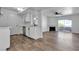 Inviting living space with hardwood floors, white cabinets, and a view of the kitchen, perfect for entertaining at 220 Mission Catalina Ln # 208, Las Vegas, NV 89107