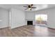 Bright living room with hardwood floors, a ceiling fan, and a fireplace, providing a comfortable living space at 220 Mission Catalina Ln # 208, Las Vegas, NV 89107