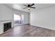 Well-lit living room features hardwood floors, fireplace, and balcony access, creating a relaxing retreat at 220 Mission Catalina Ln # 208, Las Vegas, NV 89107