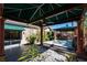 Spacious backyard featuring a covered patio with jacuzzi, ample greenery, and privacy at 2279 Pacini Ct, Henderson, NV 89052