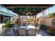 Backyard patio featuring dining table, outdoor kitchen under a shaded pergola at 2279 Pacini Ct, Henderson, NV 89052