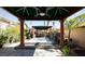 Backyard patio featuring jacuzzi, rock waterfall, outdoor kitchen and covered dining area at 2279 Pacini Ct, Henderson, NV 89052