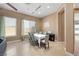 Bright dining room featuring tile flooring, large windows, and a modern chandelier over the table at 2279 Pacini Ct, Henderson, NV 89052