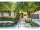 Charming single-story home with mature trees, front yard landscaping, and a two-car garage at 2279 Pacini Ct, Henderson, NV 89052