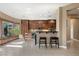 Bright and open kitchen area featuring custom cabinetry, tile flooring and a breakfast bar seating area at 2279 Pacini Ct, Henderson, NV 89052