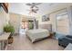 Bright main bedroom with a ceiling fan, access to a patio, and ample natural light at 2279 Pacini Ct, Henderson, NV 89052