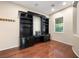Dedicated office space featuring built-in shelving, wood flooring, and natural light at 2279 Pacini Ct, Henderson, NV 89052