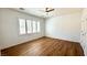 Serene bedroom with wood floors, white walls, plantation shutters, and ample natural light at 2535 Jada Dr, Henderson, NV 89044