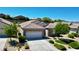 Charming single-story home featuring a two-car garage, stone facade, and desert-friendly landscaping at 2535 Jada Dr, Henderson, NV 89044