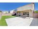 Spacious backyard with concrete patio, artificial grass, and brick fence at 262 Calvino Ave, Las Vegas, NV 89183