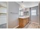 Bathroom featuring a wooden vanity with double sinks and a large mirror at 262 Calvino Ave, Las Vegas, NV 89183