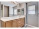 Bathroom featuring a wooden vanity with double sinks and a large mirror at 262 Calvino Ave, Las Vegas, NV 89183