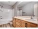 Well-lit bathroom with wood vanity, a large mirror, and a shower-tub combination at 262 Calvino Ave, Las Vegas, NV 89183