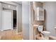 Convenient half bathroom showcasing a pedestal sink, cabinet, and adjacent staircase at 262 Calvino Ave, Las Vegas, NV 89183