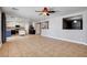 Spacious living room with tile floors, ceiling fan, and open layout to the kitchen at 262 Calvino Ave, Las Vegas, NV 89183