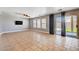 Bright living room featuring tile floors, neutral walls, and sliding glass doors to backyard at 262 Calvino Ave, Las Vegas, NV 89183