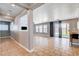Open-concept living space with tiled floors, modern lighting, and glass door access to backyard at 262 Calvino Ave, Las Vegas, NV 89183