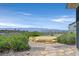 Mountain view backyard with desert landscaping and a stone fire pit at 2899 Brook Trout Ct, Henderson, NV 89052
