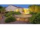 Exterior view showcasing a backyard area with a patio and landscaped surroundings at 2899 Brook Trout Ct, Henderson, NV 89052