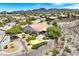 Stunning property displaying a landscaped backyard with a built-in firepit and mature trees at 2899 Brook Trout Ct, Henderson, NV 89052