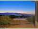 Backyard area with a stone firepit featuring mountain and city views at 2899 Brook Trout Ct, Henderson, NV 89052