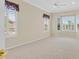Bedroom with large windows and neutral carpet features a ceiling fan at 2899 Brook Trout Ct, Henderson, NV 89052