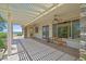 Relaxing covered patio with ceiling fans, bench seating, and desert views at 2899 Brook Trout Ct, Henderson, NV 89052