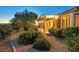 Charming exterior view showcasing a covered patio and beautifully landscaped yard at dusk at 2899 Brook Trout Ct, Henderson, NV 89052