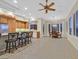 Bright kitchen with tile floors, counter seating, stainless steel appliances, and an adjacent breakfast nook at 2899 Brook Trout Ct, Henderson, NV 89052