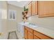 Laundry room boasts a window, modern washer and dryer, and abundant cabinet space with decor at 2899 Brook Trout Ct, Henderson, NV 89052