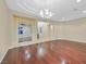 Open-concept living room with hardwood floors, recessed lighting, and elegant chandelier at 2899 Brook Trout Ct, Henderson, NV 89052