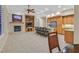 Spacious living area with fireplace, built-in shelving, island seating, and stainless steel appliances at 2899 Brook Trout Ct, Henderson, NV 89052