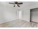 Minimalist bedroom with wood-look floors, ceiling fan, and closet space at 2915 Cedar Ave # 12C, Las Vegas, NV 89101