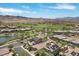 An aerial view features a pond and a golf course within a residential area at 3 Vicolo Sebino, Henderson, NV 89011