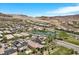 An aerial community view featuring a pond with palm trees in a desert landscape at 3 Vicolo Sebino, Henderson, NV 89011