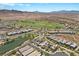 Expansive aerial showcases homes near a golf course, pond, and mountainous backdrop at 3 Vicolo Sebino, Henderson, NV 89011