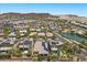 Aerial view of a planned residential community near a pond with desert hills at 3 Vicolo Sebino, Henderson, NV 89011