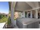 A covered back patio with a hot tub and sliding glass door leading into the living room at 3 Vicolo Sebino, Henderson, NV 89011