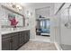 A full bathroom features double sinks, granite counters, tile accents, and modern fixtures, adjoined to main bedroom at 3 Vicolo Sebino, Henderson, NV 89011