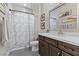 Well-lit bathroom with white marble countertops, framed mirror, and gray tile flooring at 3 Vicolo Sebino, Henderson, NV 89011